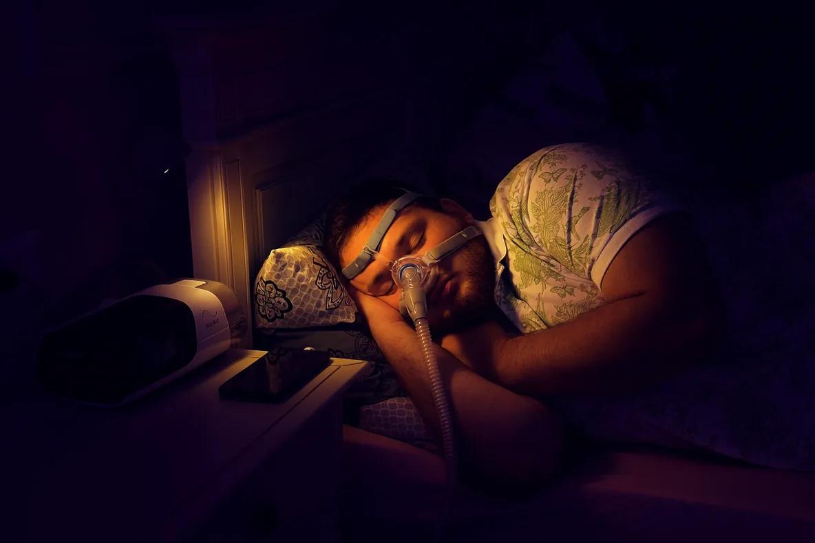Pacient care doarme cu mască CPAP